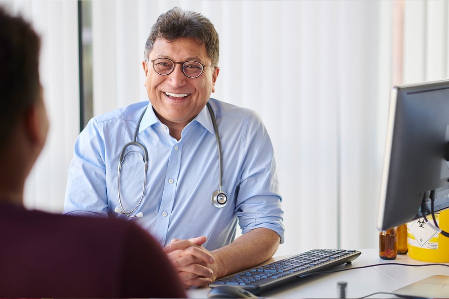 doctor talking to patient across desk