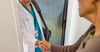 Clinician shaking hands with member at their doorway
