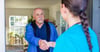 Clinician shaking hands with member at the front door