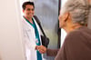 Clinician shaking hand at door