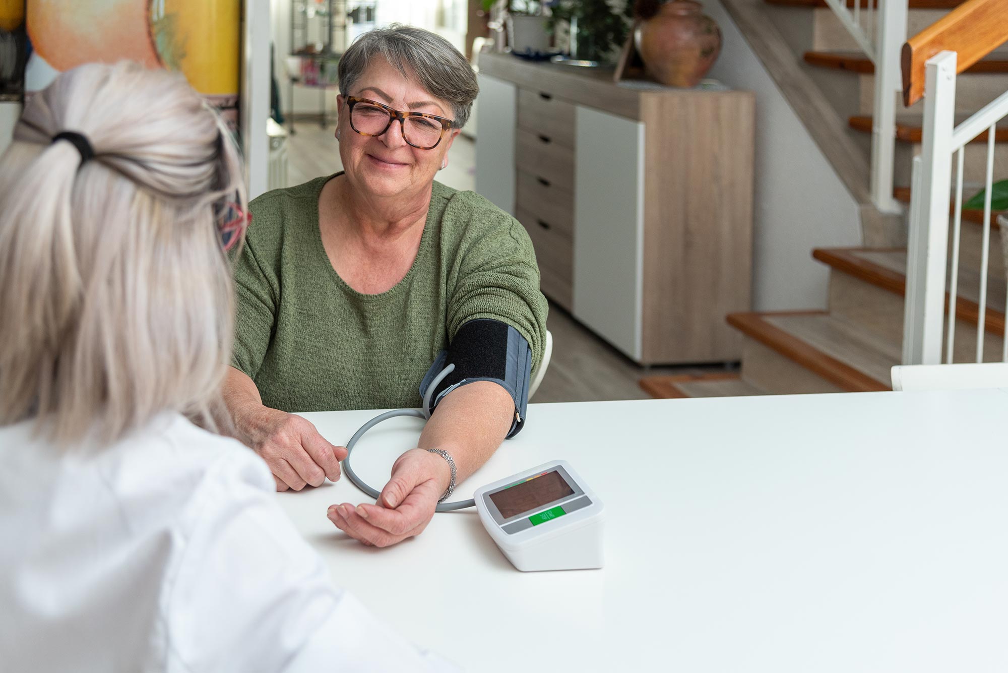 A member has her blood pressure checked as part of preventive care