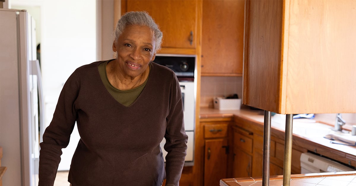 Member in kitchen looking towards camera.