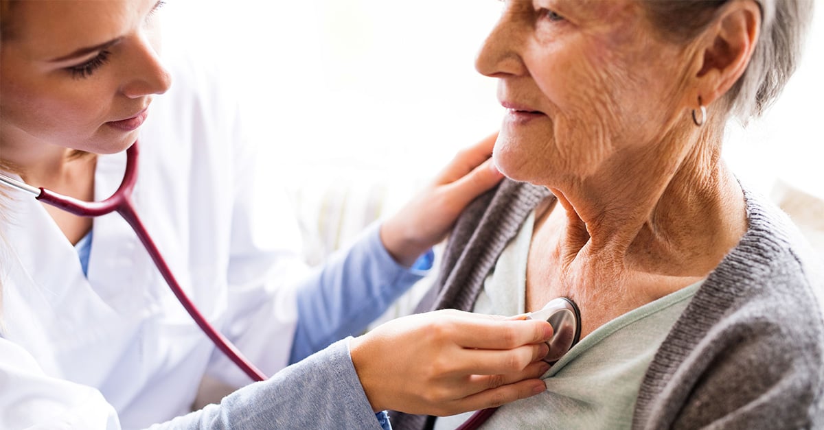Clinician with stethoscope listening to member