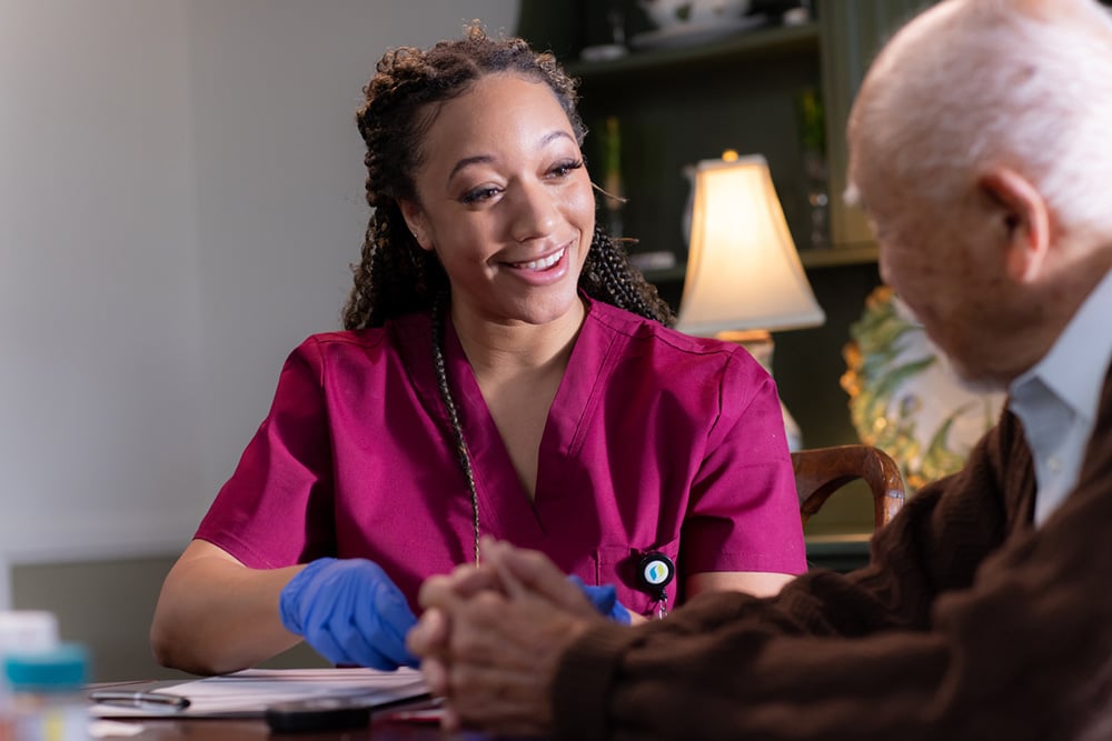 Clinician going over paperwork in home with member